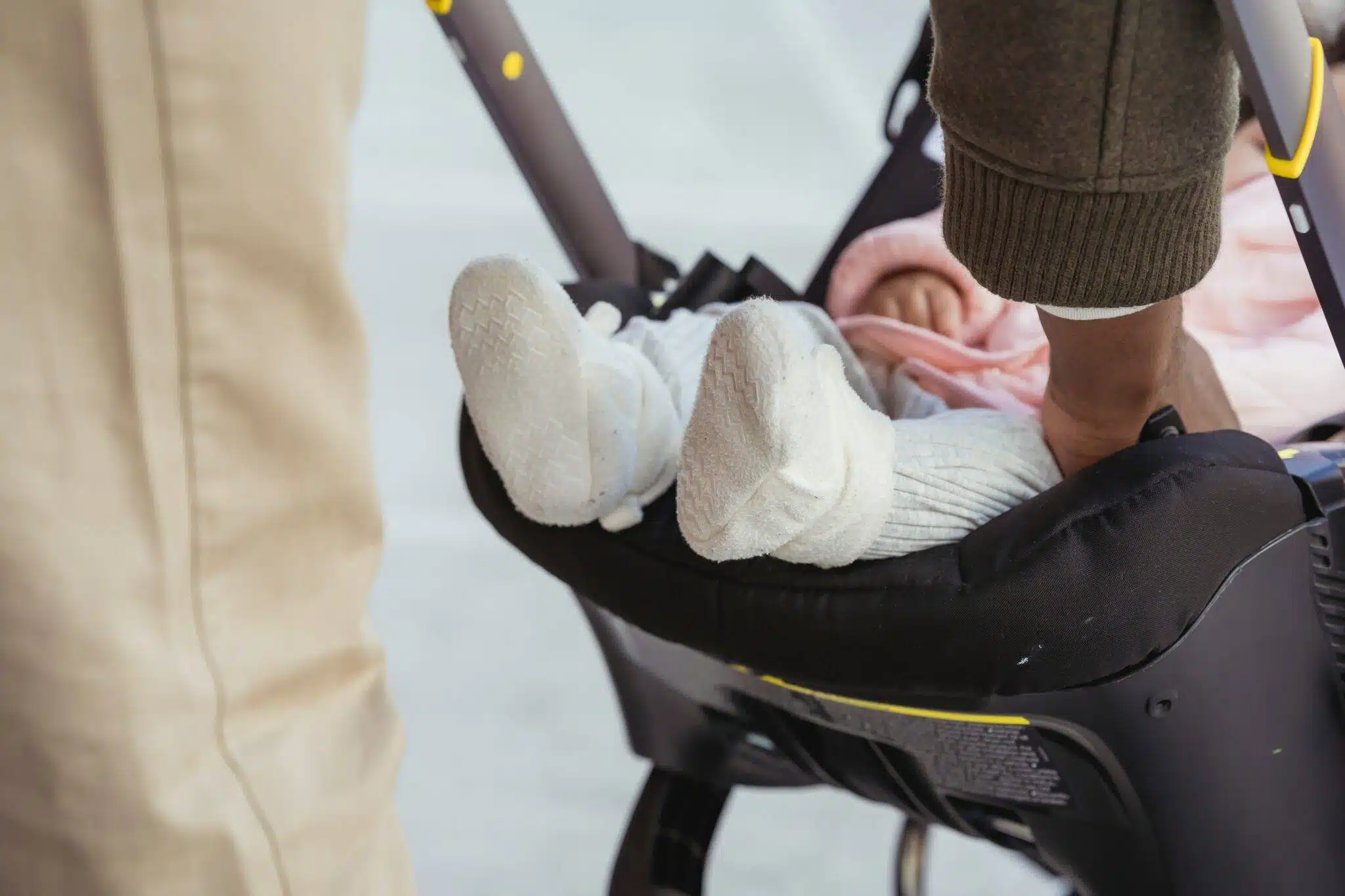 father putting baby on stroller