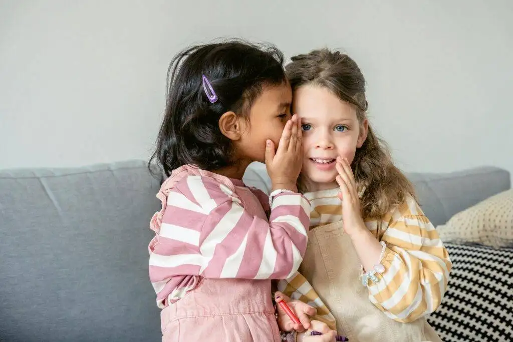 Building a Trusting Relationship with Your Child's Pediatrician 1 child whispers in ears of a trusted friend trust