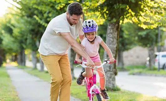 Beat Summer Boredom: 18 Ideas for Kids 4 Summer-Happy Father Teaching His Little Daughter To Ride A bike